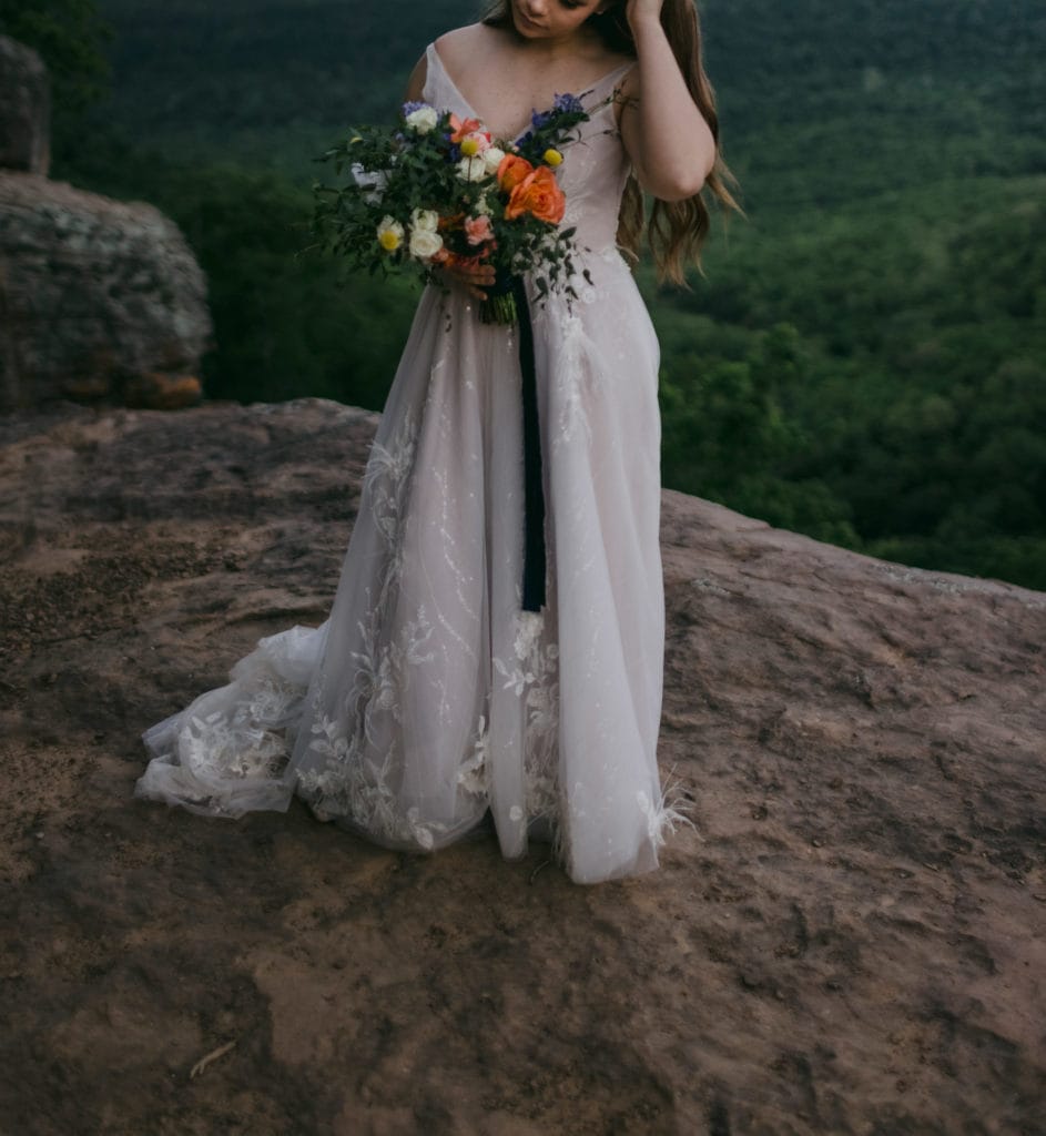 Bride holding her wedding bouquet in Yosemite National Park after her elopement.