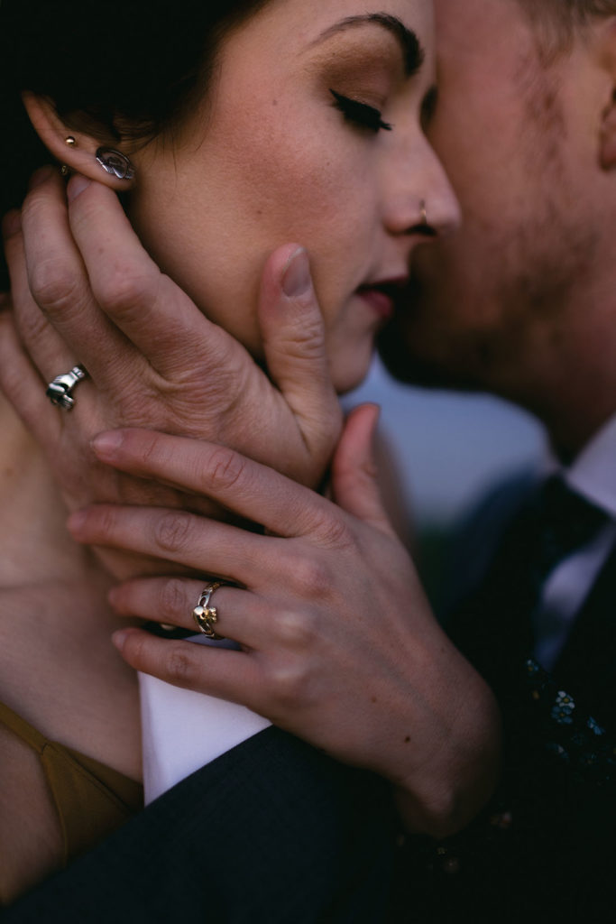 A claddaugh ring and matching earrings on a Scottish bride.